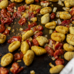 roasted gnocchi and tomatoes on a sheet pan