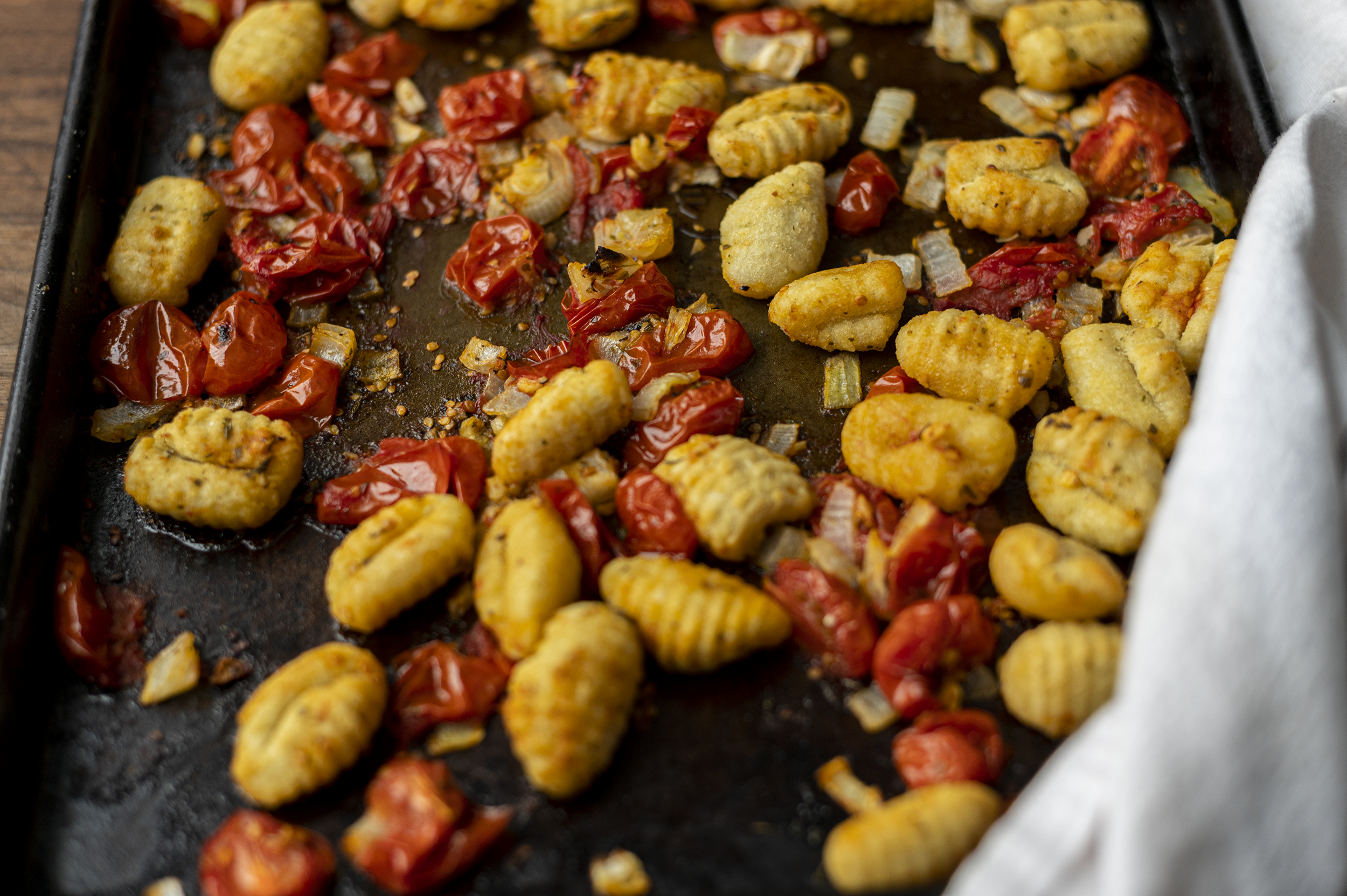 roasted gnocchi and tomatoes on a sheet pan